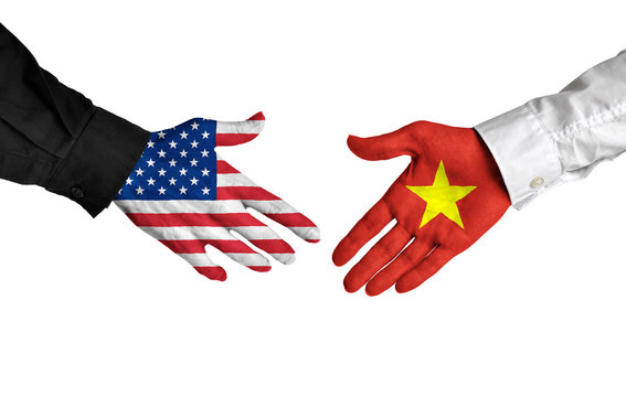 United States and Vietnam leaders shaking hands on a deal agreement