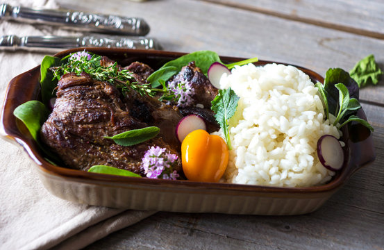 Grilled meat with rice and vegetable