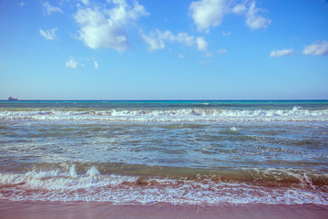 Beautiful wave on sea and blue sky with clouds