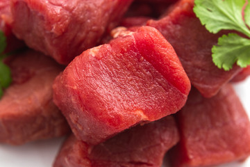beef goulash raw as background, top view