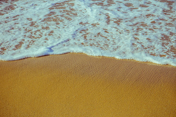 Soft foam wave of sea on sandy beach