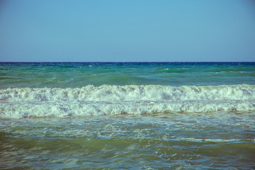 Beautiful wave on sea and blue sky with clouds
