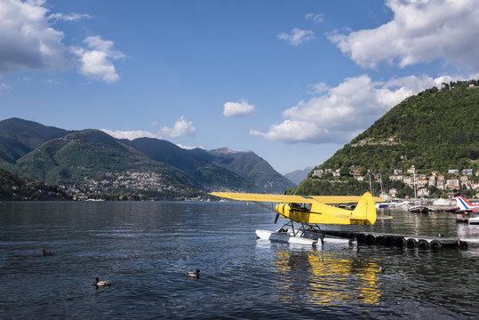 Beautiful Lake Como and Sea Plane: A spring time view of beautiful Lake Como with a yellow sea plane and ducks on the water