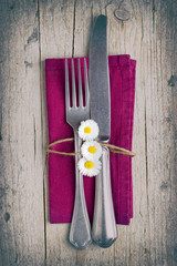 Cutlery - fork and knife on purple napkin in vintage stile