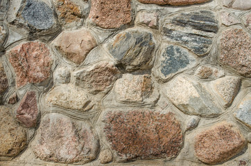 pattern gray color of modern style design decorative uneven cracked real stone wall surface with cement / Stone wall background / Medieval stone wall