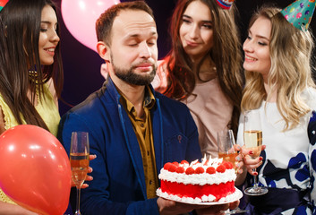 Happy birthday! Group of smiling friends gathered together with