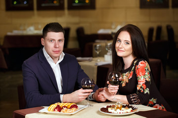Couple toasting wineglasses in a luxury restaurant