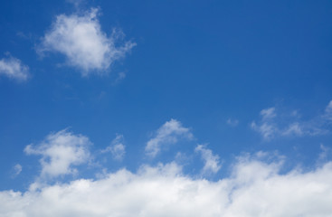 Naklejka na ściany i meble Cloudscape over horizon, white clouds in the blue sky.