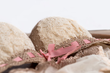 Beige set of lacy underwear on wooden background