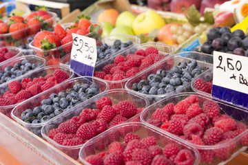 Fresh berries on fruit stall with price tag in Euro currency