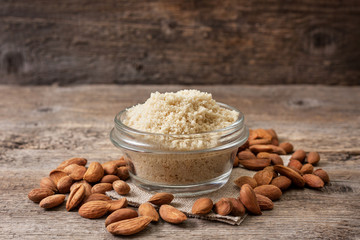 almond flour in a wooden bowl, almonds