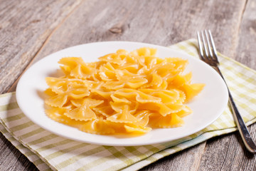 Farfalle on wooden background
