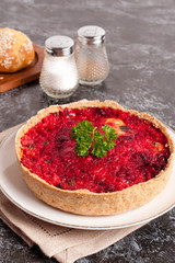 Beetroot pie with feta cheese on white plate