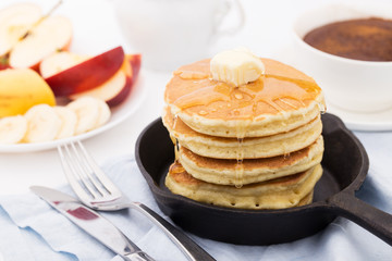 Breakfast with pancakes, honey and fruits