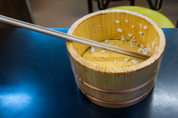 Empty vintage wooden bowl with chopsticks. The dish on a table in Japanese restaurant.