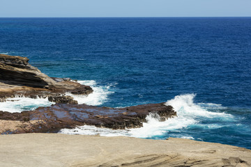 Waves breaking on the cliffs near Lanai Lookout. Gushing water is blurred due to its high velocity