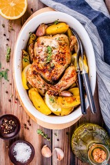 Roasted whole chicken with potatoes and thyme