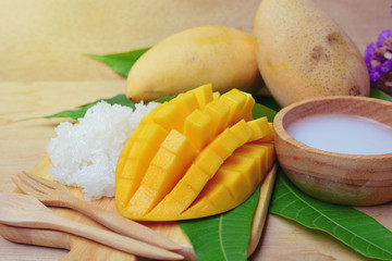 mango with sticky rice on wooden tray. thai dessert made from mango fruit. glutinous rice eat with mangoes and coconut milk. 