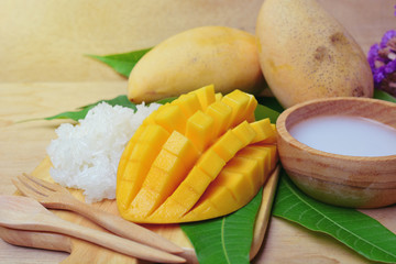 mango with sticky rice on wooden tray. thai dessert made from mango fruit. glutinous rice eat with...