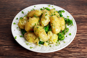 Young boiled potatoes with butter and vegetables.
