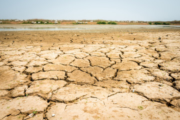cracked soil in the bottom of a river showing drought