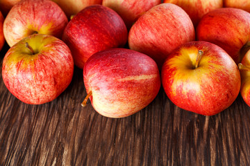 close up of fresh apples on wooden background
