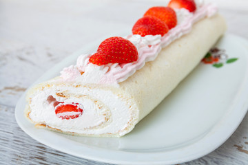 Homemade cake roll with strawberry cream