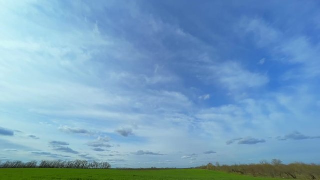 Cloudy Sky over the Green Field. Time Lapse.