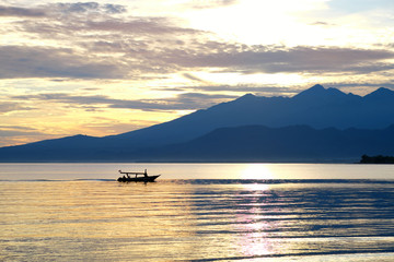 Boat with lombok volcano Rinjani in the background before the sunrise
