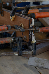 Clamps holding wood on a workbench