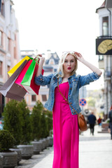 Smiling girl with shopping bags.