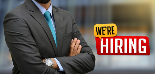 Professional with We are hiring Sign Banner