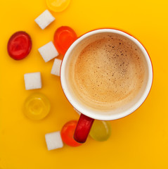 coffee cup and colorful candies and sugar