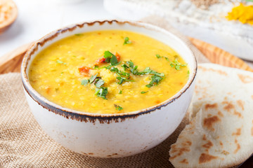Lentil soup with pita bread in ceramic white bowl