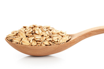 Wooden spoon with oats isolated on white background.