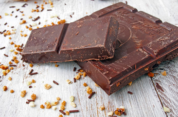 Still life of broken chocolate bar  on wooden table