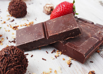 Still life of broken chocolate bar  on wooden table