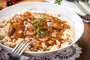 Cooked barley porridge and stew of pork.