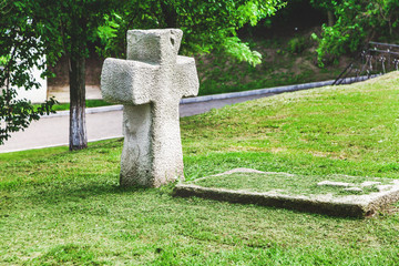 Old stone cross and tombstone