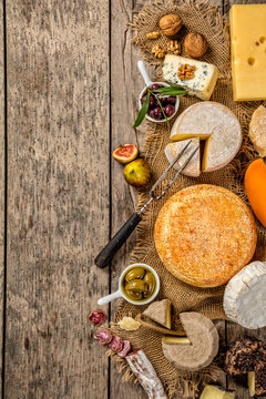 Various kind of cheese and delicacy on wood