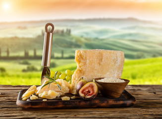Parmesan cheese on cutting board placed on wood