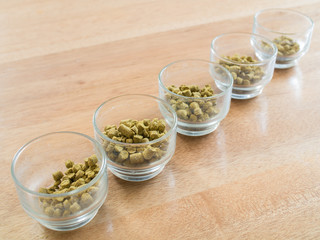 Hops pellets in glass cup for brewing beer - Beer ingredient