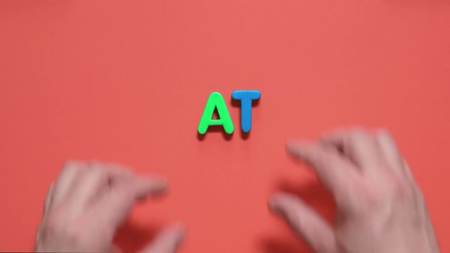 man lays out to the inscription from colored letters
