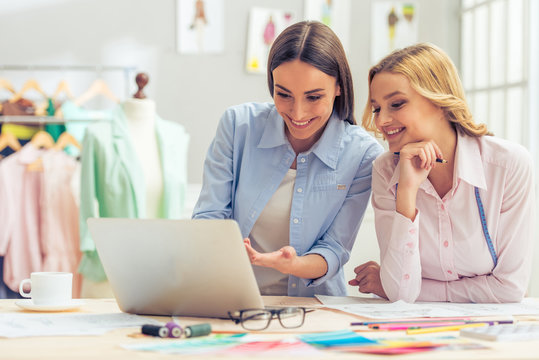 Beautiful designers working with gadget - Powered by Adobe