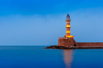 Picturesque view of Lighthouse in old harbour of Chania during twilight blue hour, Crete, Greece