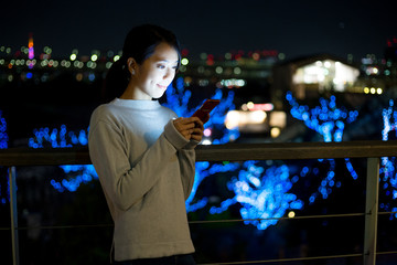 Woman use of cellphone at night