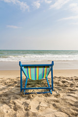 Beach chair on the beach and sea background