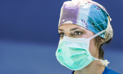 Portrait of a scrub nurse on a blue background