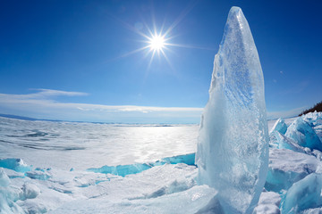Ice floe and sun on winter Baikal lake