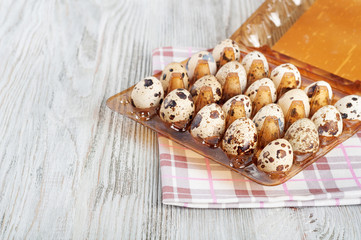 Quail eggs in a plastic box